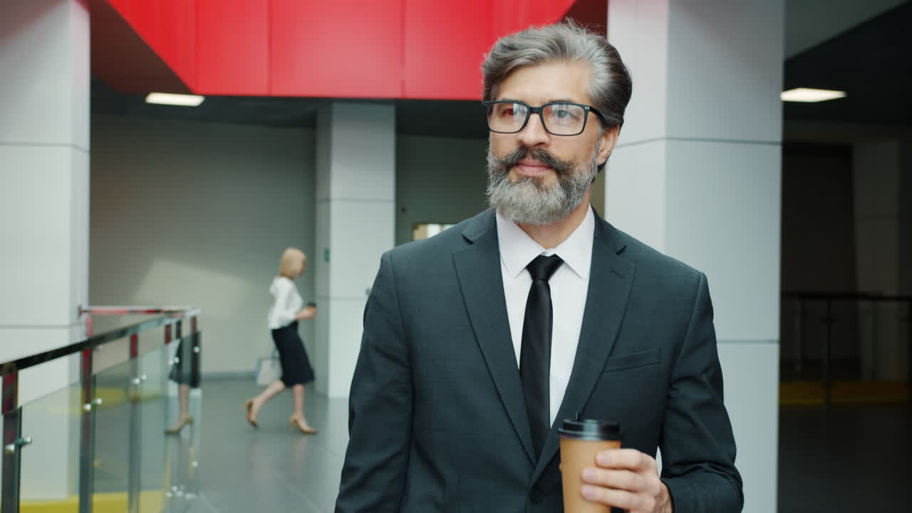 Businessman in Office Corridor with Coffee