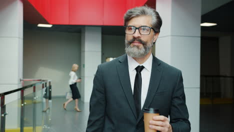 businessman in office corridor with coffee