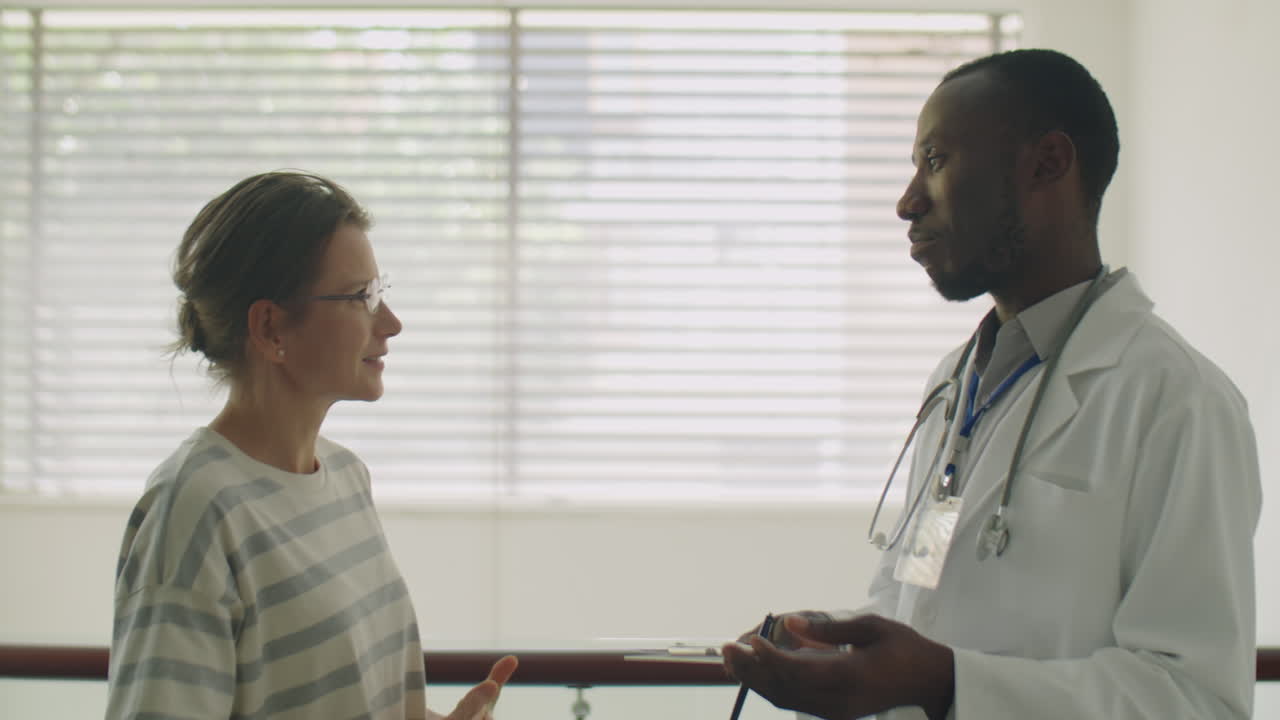 Black Doctor Communicating with Female Patient