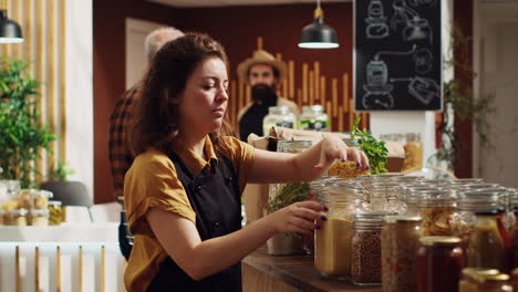 woman in shop using biodegradable jars
