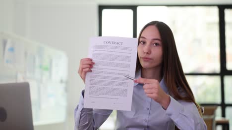woman pointing at a contract document