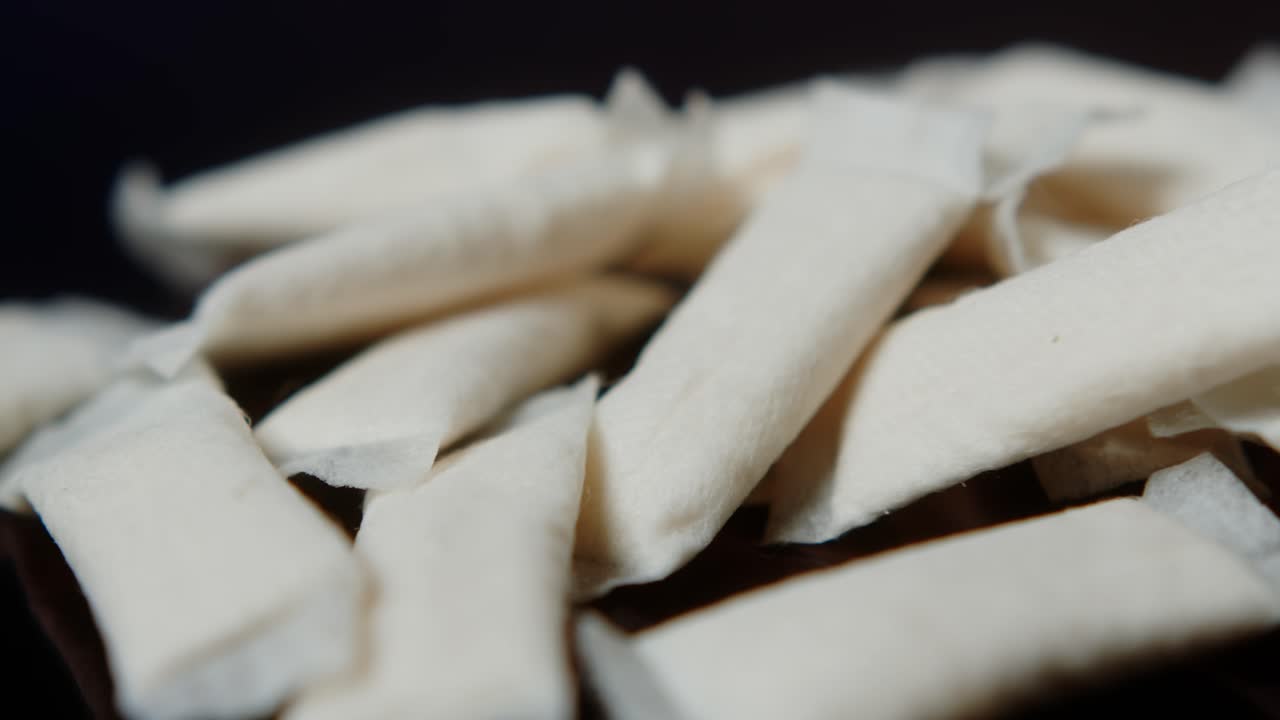 Snus nicotine tobacco close up, pack of tobacco for gum. unhealthy addiction. Man opening box with snus and taking one.