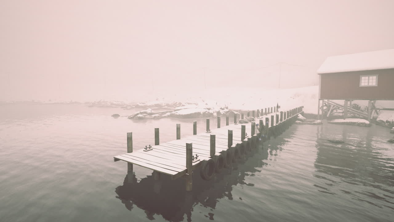 Winter scene with pier, building, and heavy fog