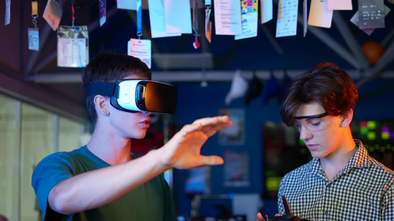 Young engineers with VR virtual reality headset controlling virtual worlds in research laboratory