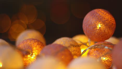 teal orangy ball fairy lights flaring for holiday christmas closeup