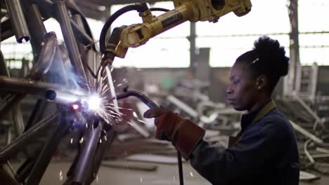 Skilled Welder in Action: A Focused Technician Employs a Welding Torch to Merge Metal Components with Precision Amidst Industrial Surroundings