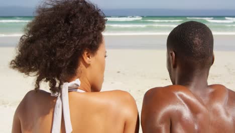 couple relaxing together at beach on a sunny day 4k