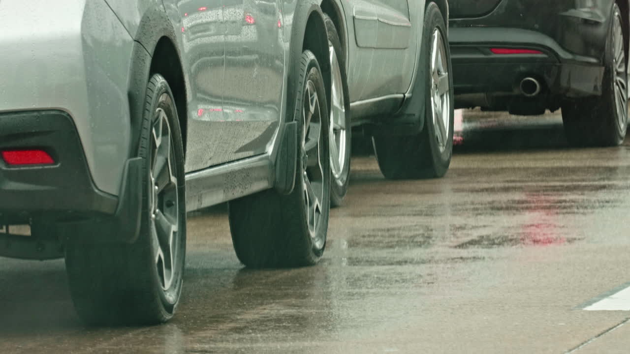 Car moving and stopping in traffic jam on rainy American highway