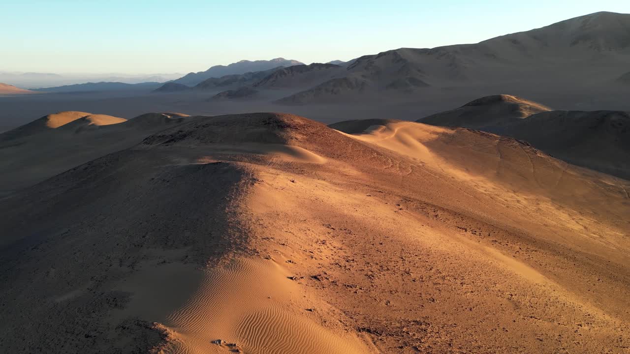 Epic panorama of arid wilderness where the Medanoso dune rises over the desert at twilight