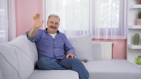 Happy-old-man-waving-at-camera.