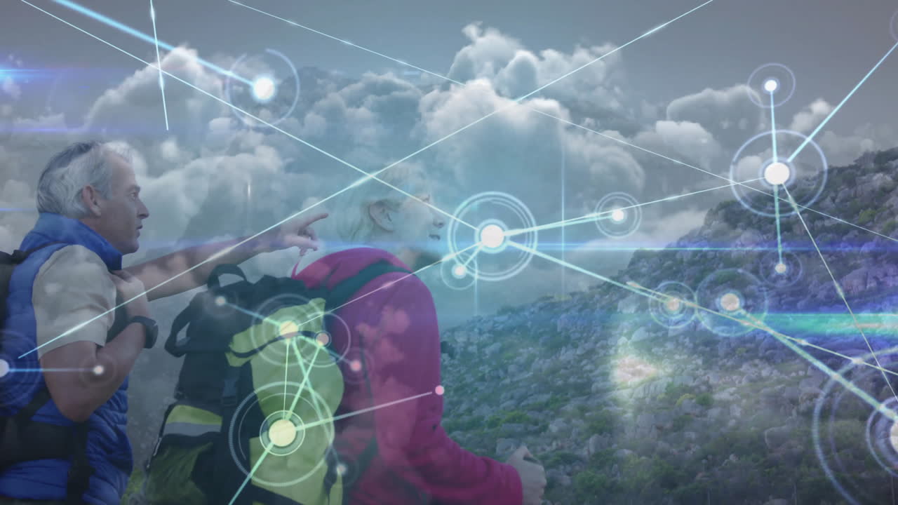 couple standing surveying ridge with backpacks, digital nodes overlay blending technology motifs