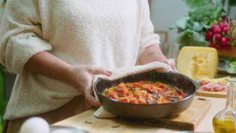 woman cooking a vegetable dish in the kitchen