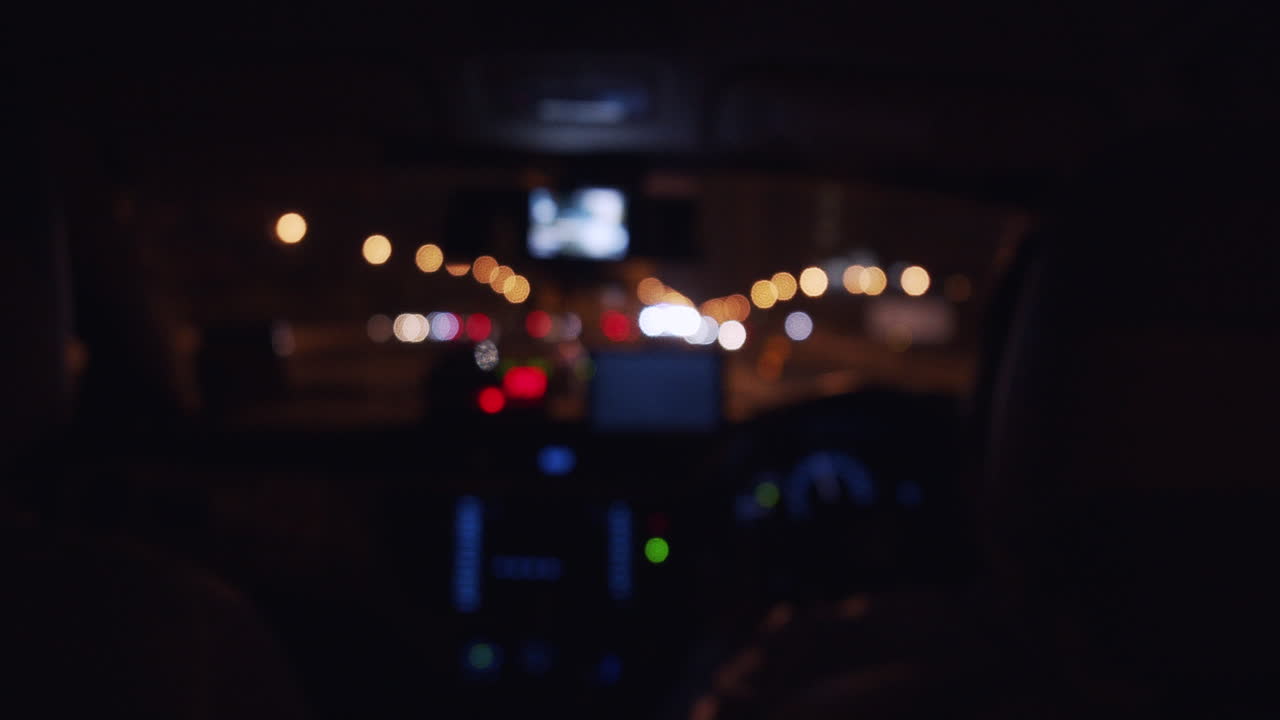 Taxi driver at night on the highway with car lights - blurred