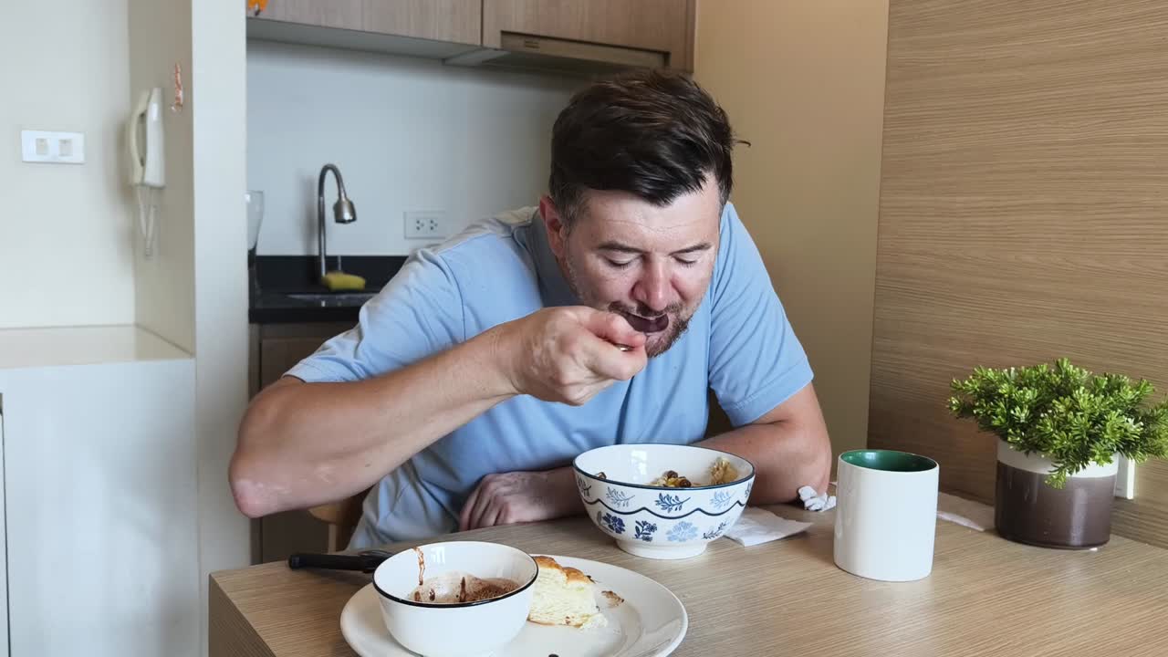Man Eating Cereal at Table Indoors