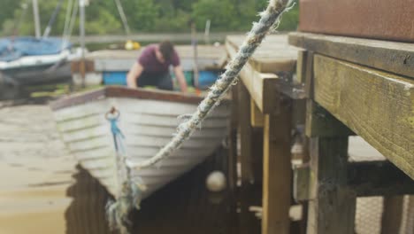 a young man bails out a fiberglass fishing boat