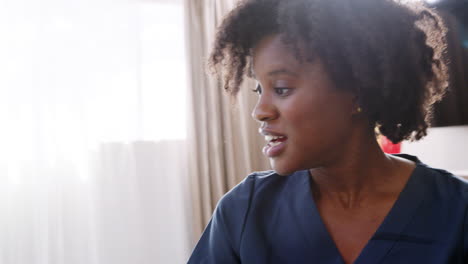 Close-Up-Of-Nurse-Making-Home-Visit-To-Patient-In-Bedroom