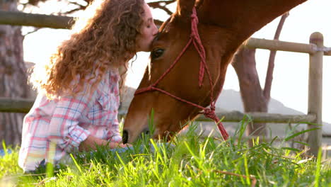 woman kissing horse