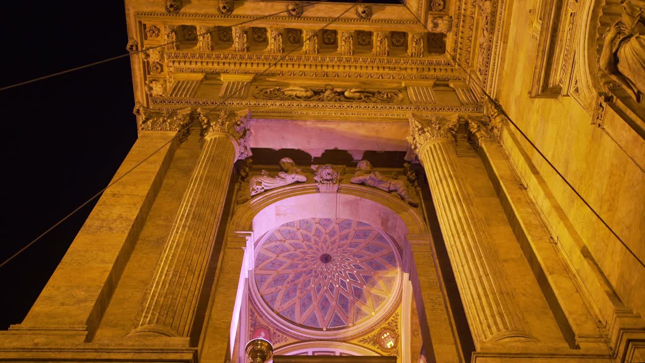 facade of the architecture of a historic building illuminated at night, in Prague, Czech Republic