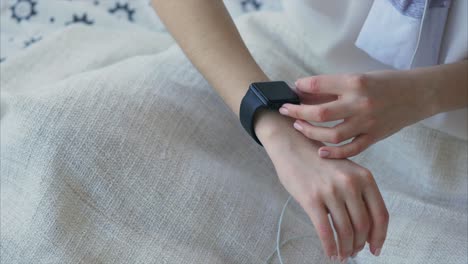 woman adjusting smartwatch on wrist