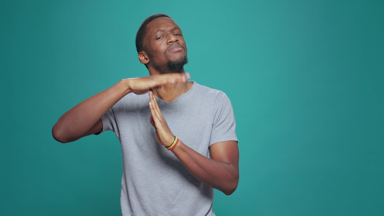 Serious tired person advertising timeout symbol with hands