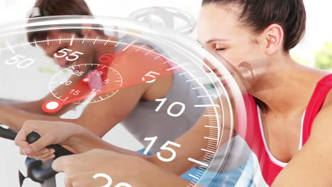 stopwatch graphic over couple using exercise bikes