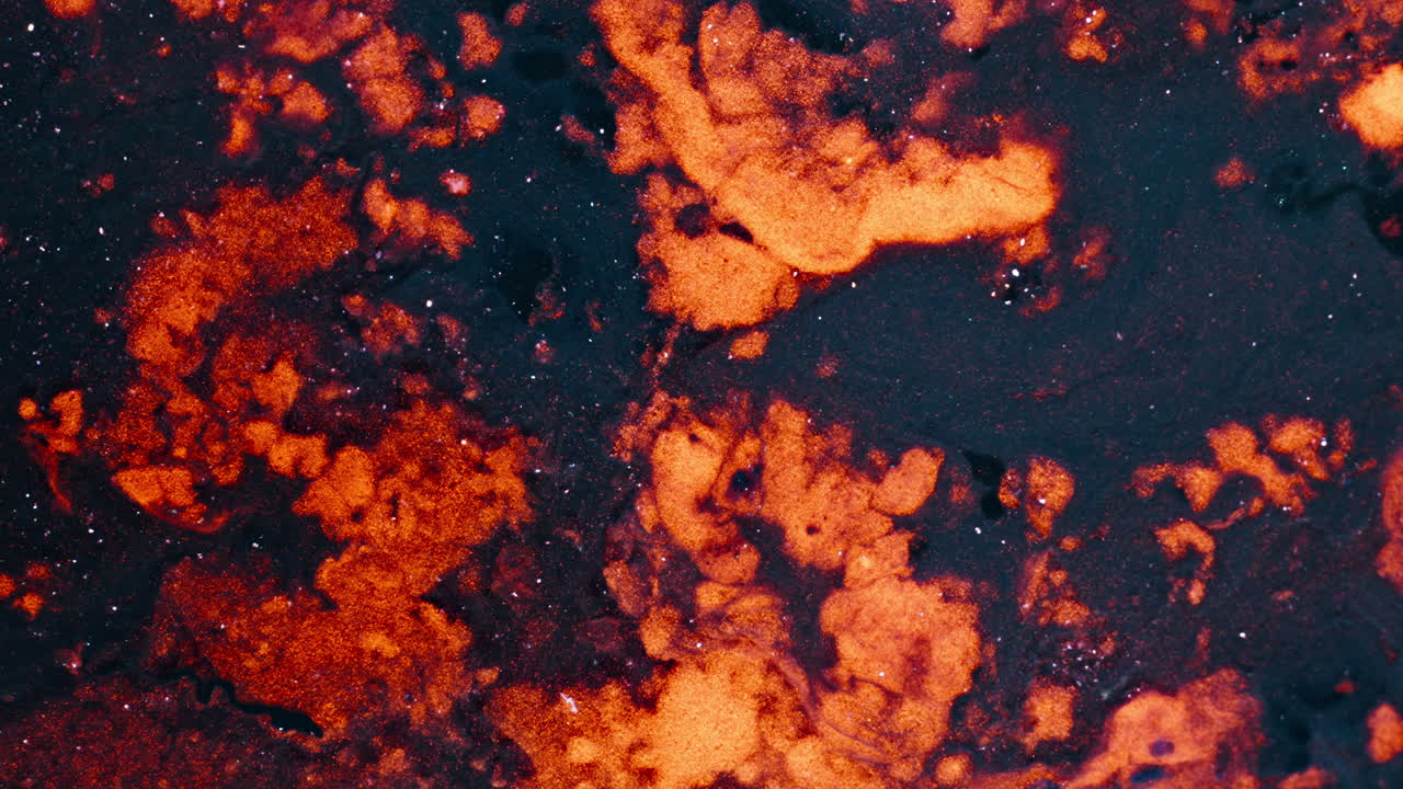 Macro shot of particles dissolving in liquid, abstract visual effect