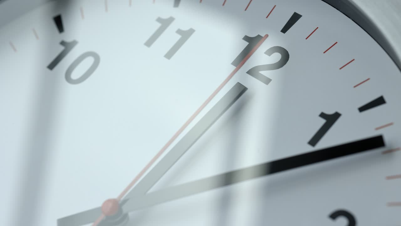 Large white wall clock Set the time for 12.00 o'clock. The red minute hand keeps running. Time lapse movie.