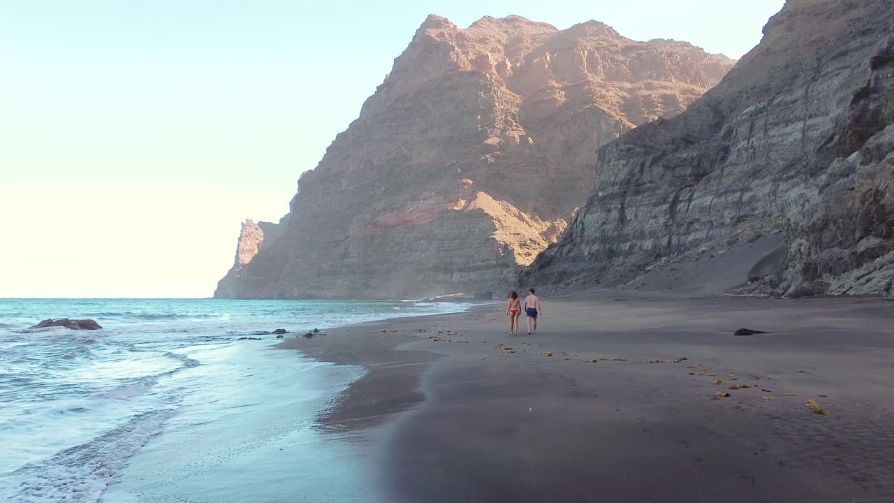 escena idílica de dos personas en una playa virgen intacta en gran canaria, españa durante el verano en vacaciones