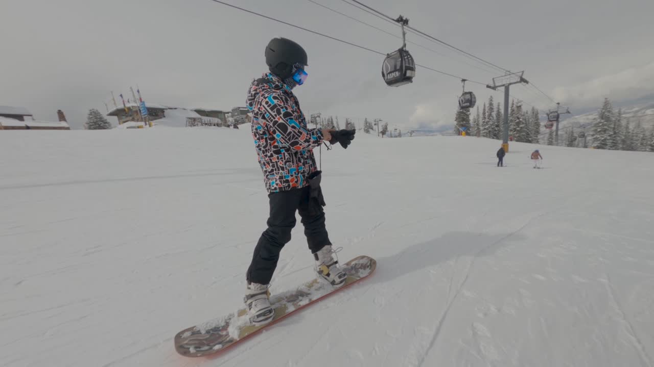Snowboarder going down a  slope of Aspen. Winter extreme sports concept