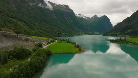 Drone-flight-over-Oldevatnet-lake-in-scenic-Oldedalen-valley,-Norway