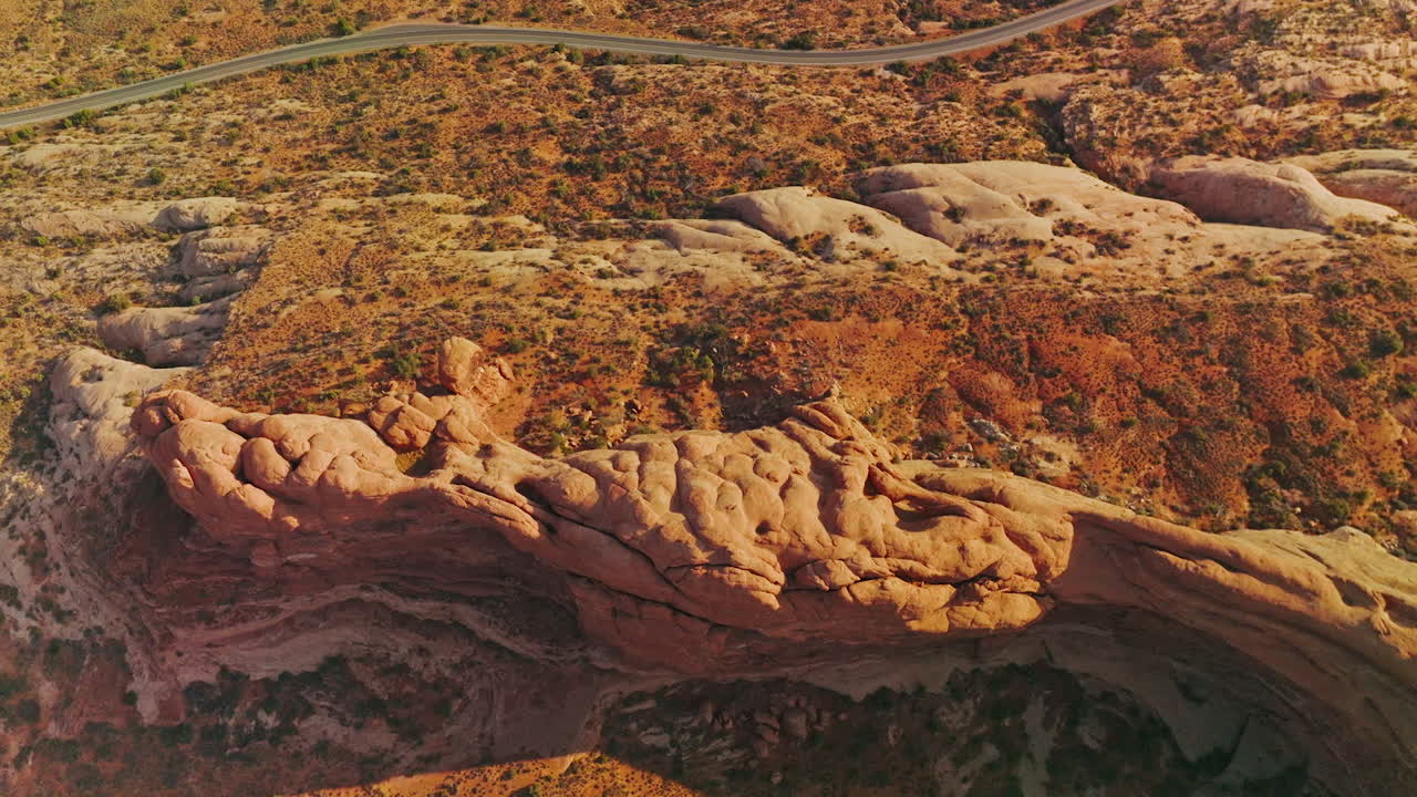 Amazing landscape of Arches National park in America. Highway going parallel to the beautiful canyon rock. Top view.