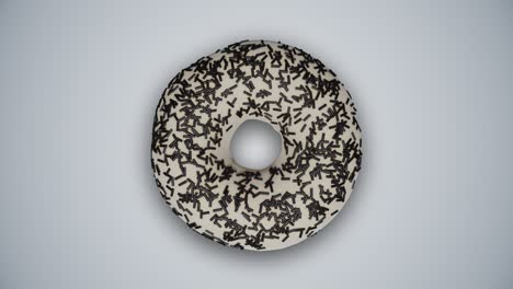 sabrosas rosquillas vidriadas de colores con salpicaduras cambiándose entre sí en un fondo gris abstracto