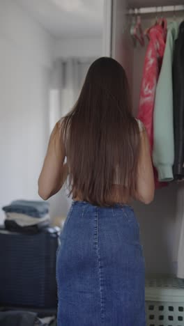 woman getting dressed in her bedroom