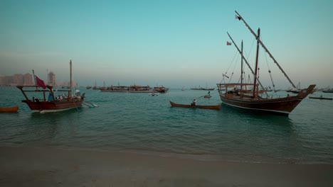 traditional arabic fishermen with dhows with qatar flag in arabic gulf