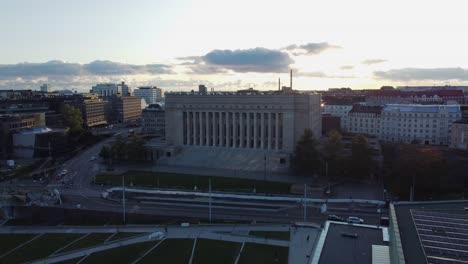 Low-evening-Helsinki-aerial-passes-massive-Parliament-House-building