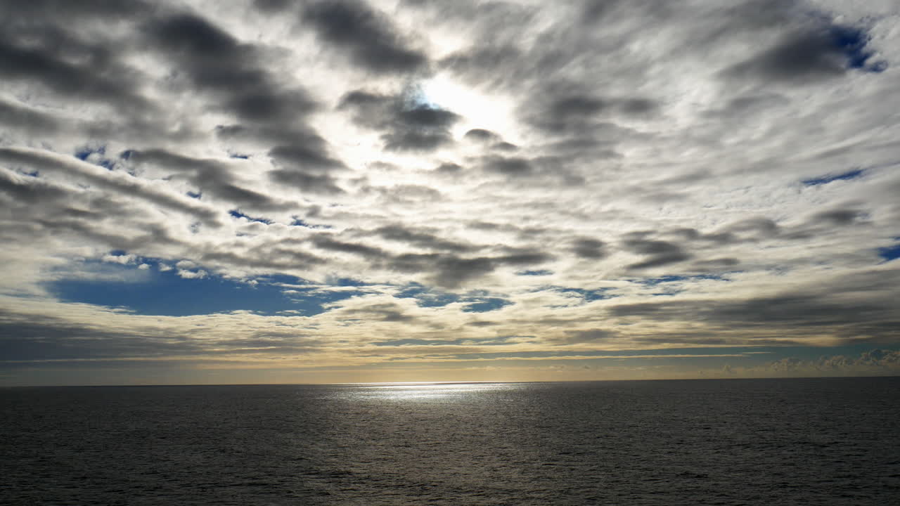 Setting sun form moving cruise ship.