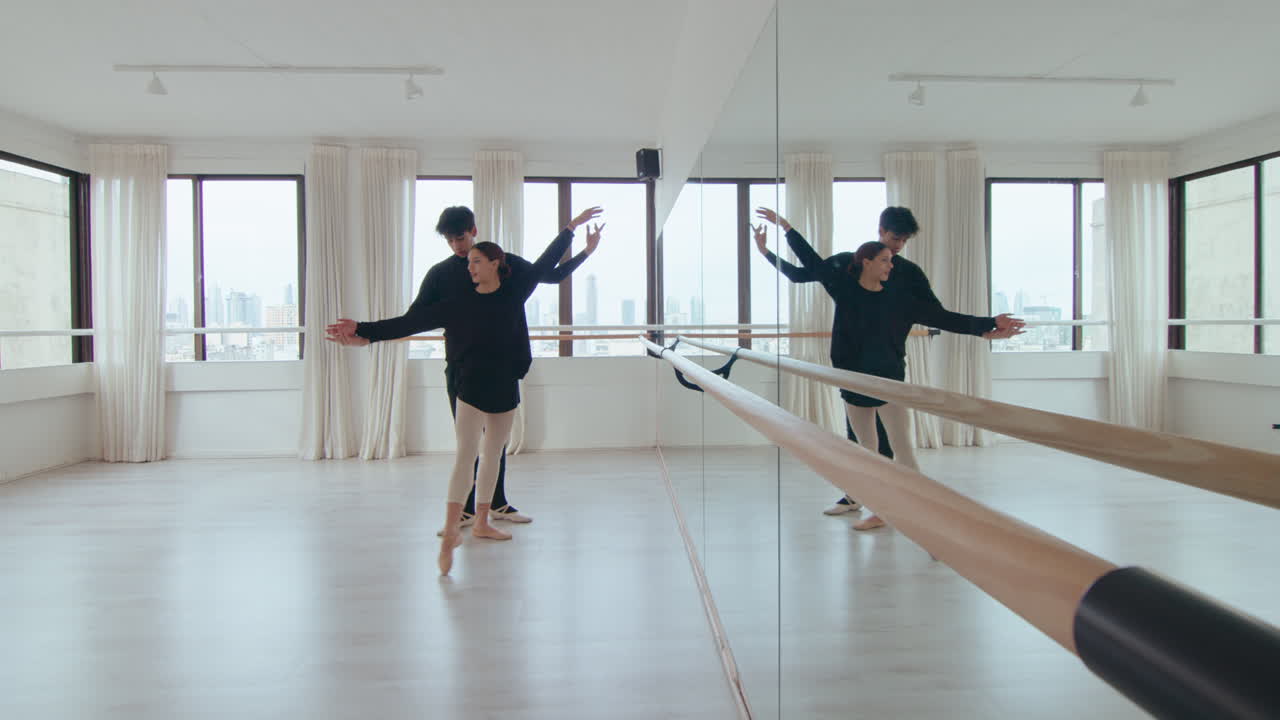 Young Ballet Duet Practicing Synchronic Moves in Dance Studio