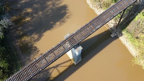 rocket shot of railroad track going over river