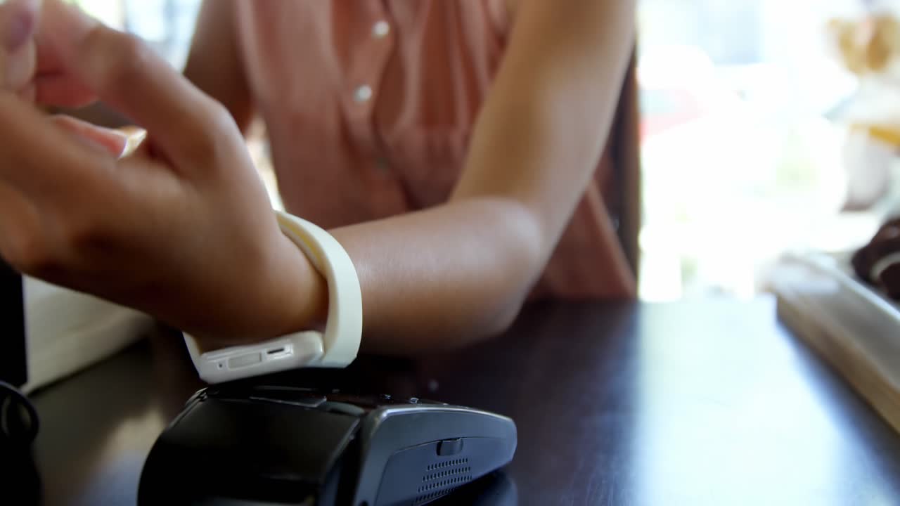 Teenage girl making payment through smartwatch 4k