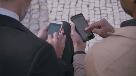 multicultural men using smartphones