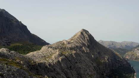 rocky mountain range summit above gorg blau water reservoir, mallorca