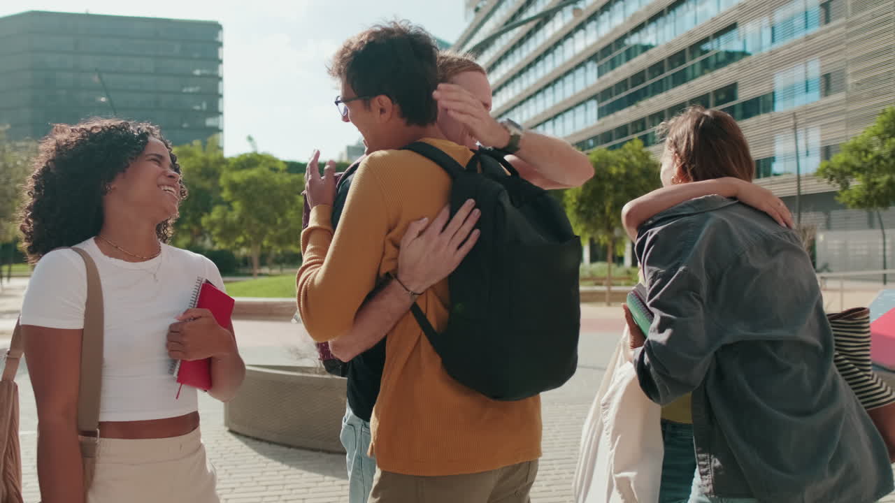 Attractive students talking outdoors and walking. Male and two female teenagers,