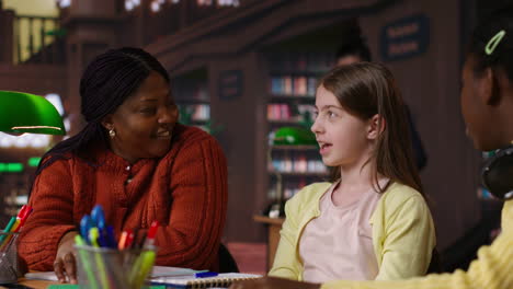 teacher and students in a library