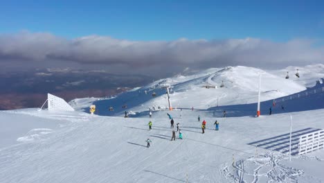 4k aerial of skiers on jahorina mountain in winter snow, bosnia and herzegovina