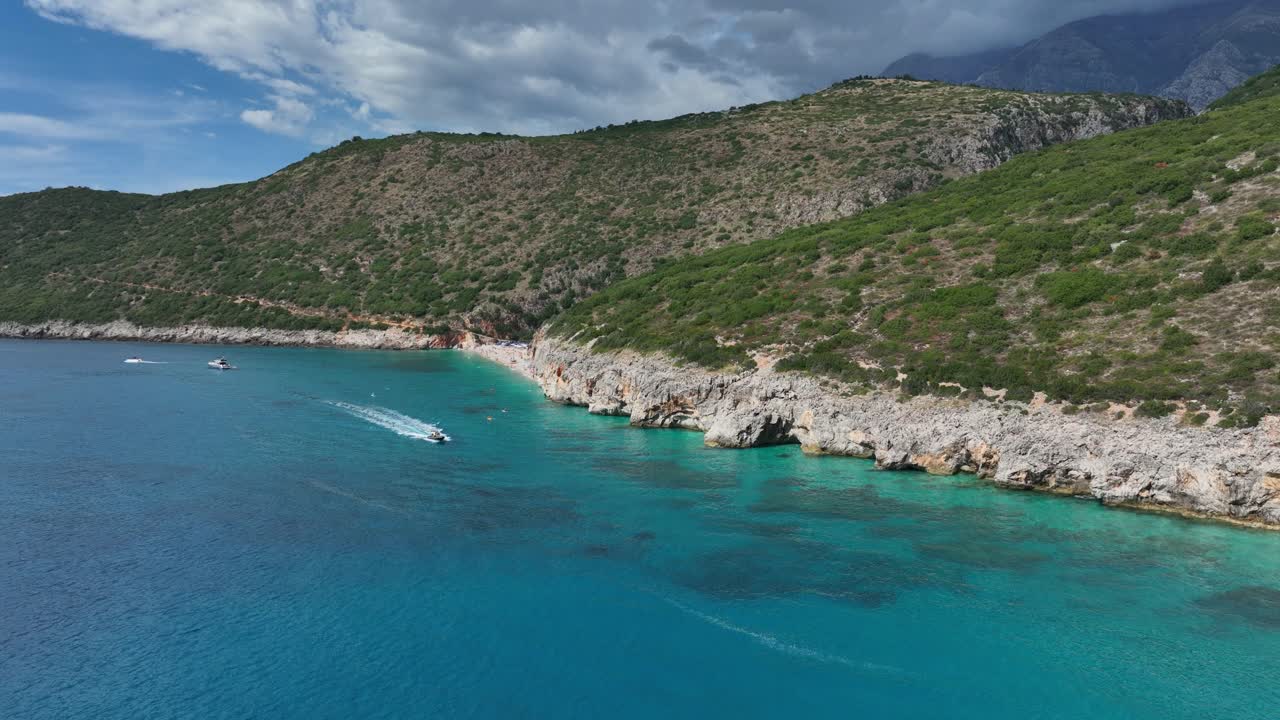 Aerial view of a boat sailing near Gjipe beach in Albania.