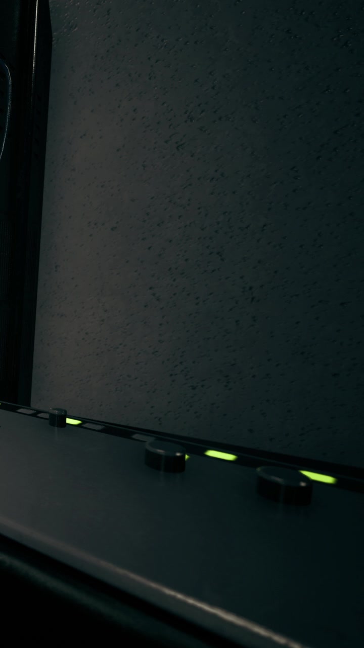 Control panel shows lights and switches in a darkened room