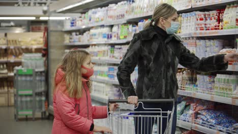 mom and daughter, buyers in the mall, choose products. they carefully examine the counters when making their choice.