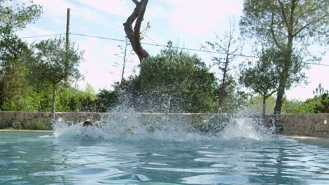 family on vacation jumping into outdoor pool