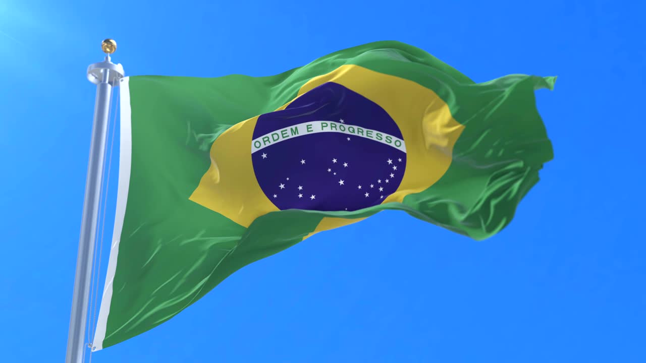 bandera de brasil agitando el viento en lento con el cielo azul, bucle