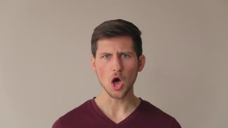 young man being surprised and acting in negation with strong emotions, medium close-up facing camera still shot